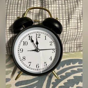 23 Black and gold battery powered alarm clock.